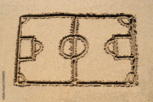 a soccer pitch drawn on a sandy beach.