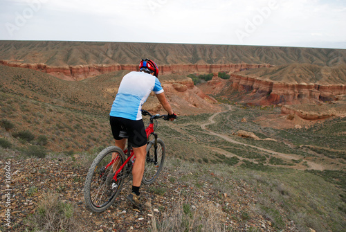 mountain biker downhill to canyon temirlik