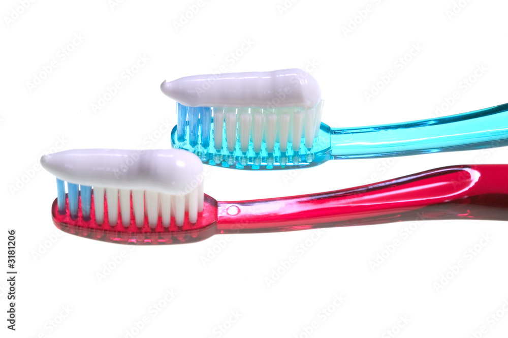two loaded toothbrushes two loaded toothbrushes