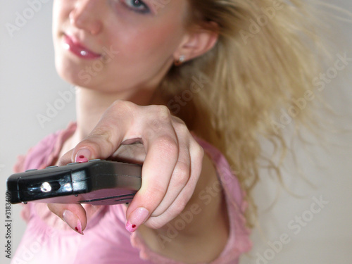 remote control in girl's hand photo