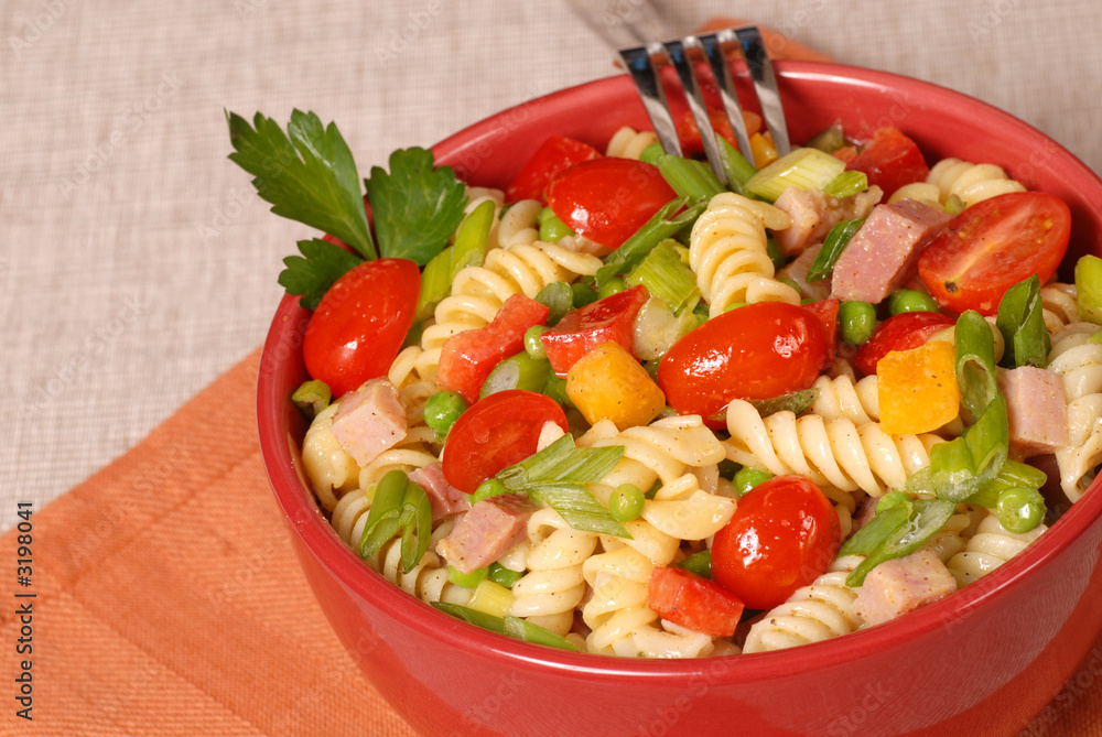 fresh pasta salad in a red bowl fresh pasta salad in a red bowl
