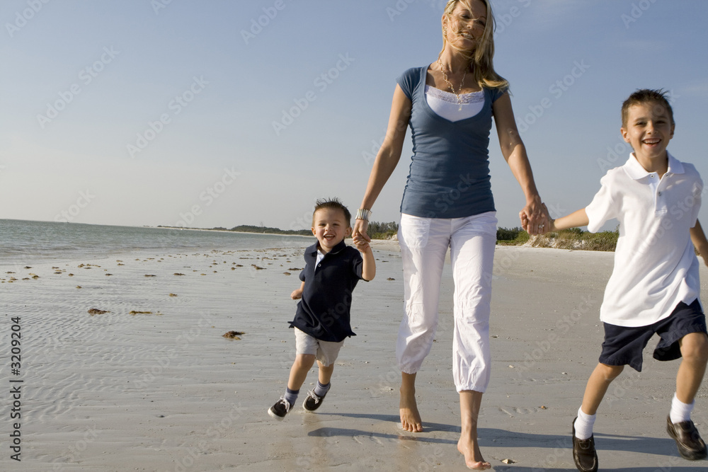 mom with kids on a beach mom with kids on a beach