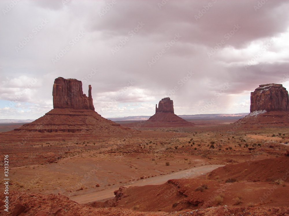 monument valley in a haze of reddish clouds monument valley in a haze of reddish clouds