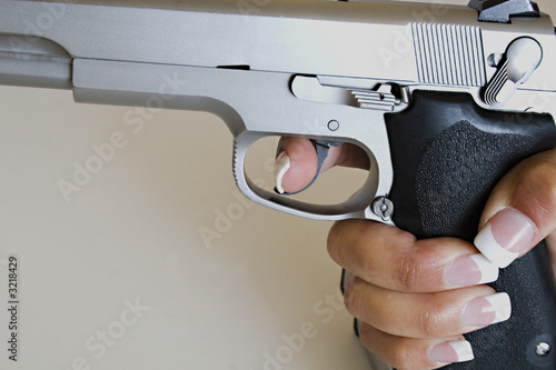 female hand gripping gun
