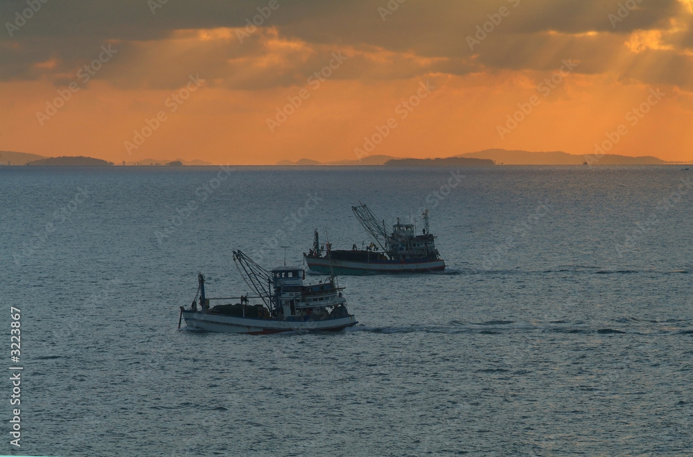 fishing boats at sunrise