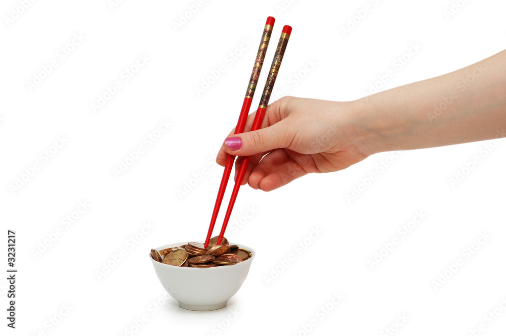 hand with red chopsticks eating golden coins hand with red chopsticks eating golden coins