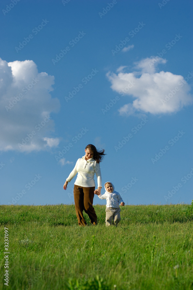 mother and baby running on the meadow mother and baby running on the meadow