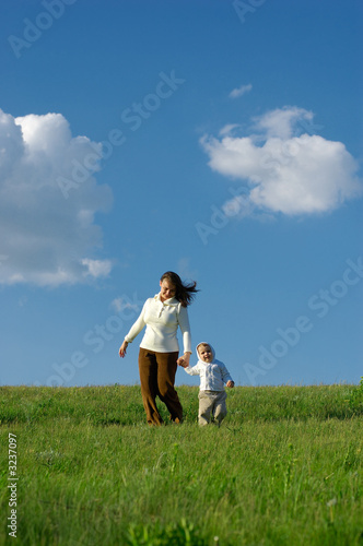 mother and baby running on the meadow