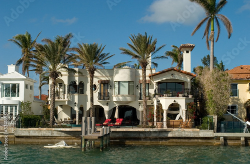 mansion with chairs and palms