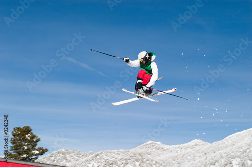 skier high in the air cross feet