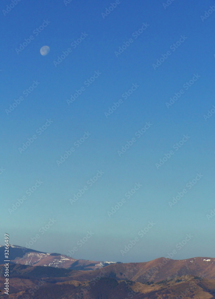 brightly sky with moon over landscape