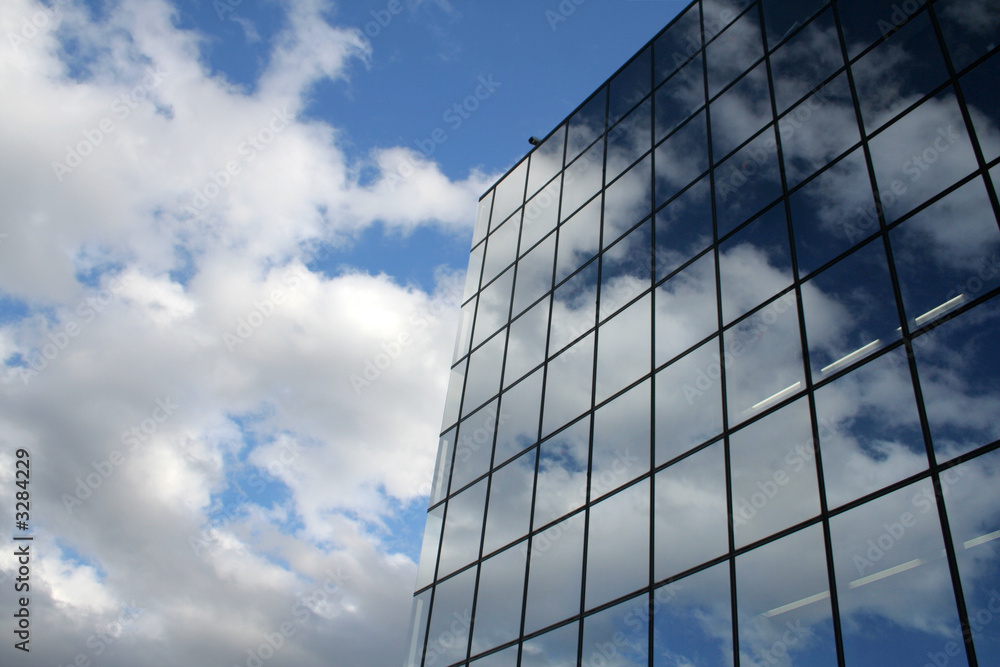 blue sky and clouds reflected in the glass buildin blue sky and clouds reflected in the glass buildin