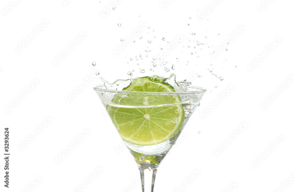 lime splashing into a cocktail glass lime splashing into a cocktail glass