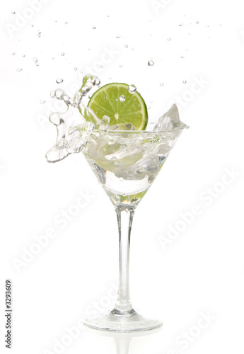 lime splashing into a cocktail glass
