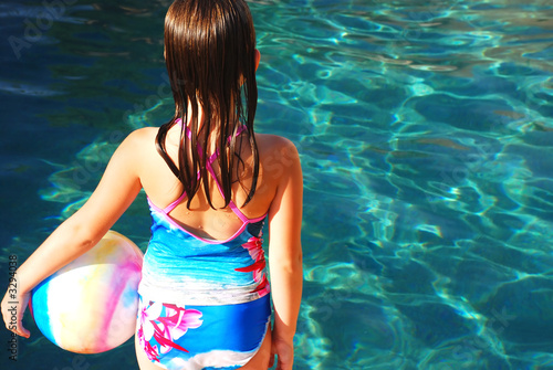 girl with ball by pool