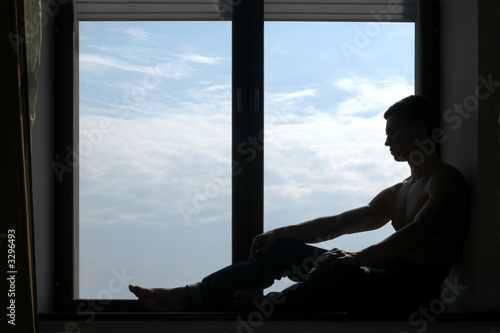 silhouetted man on the windowsill