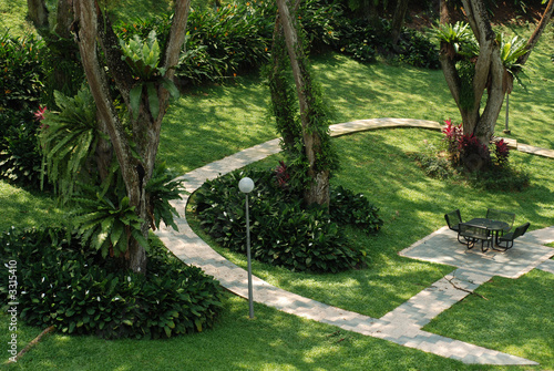 table, chairs, and plants in the gardens
