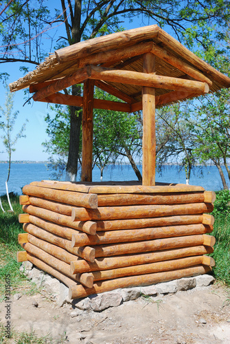 Fototapet wooden well in garden