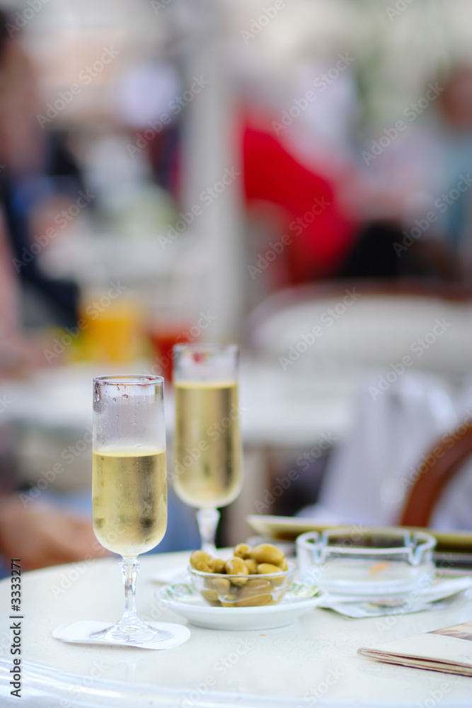 two wine glasses with some olives in a cafe two wine glasses with some olives in a cafe