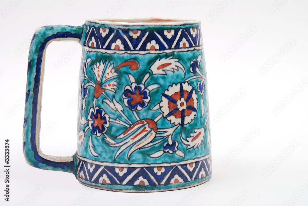 an antique persian large tankard in iznik design an antique persian large tankard in iznik design