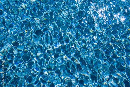 sunlight ripples on blue water