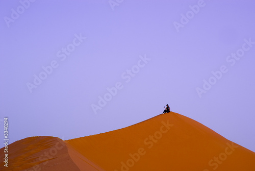 a man on the dunes at sunset