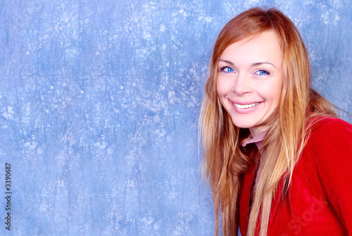 smiling young woman portrait, in red. studio shot