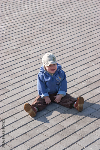 child on the ground smiling