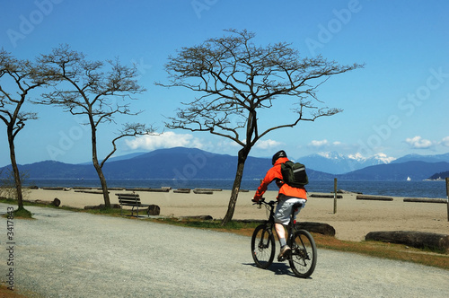 man bicycling on beach