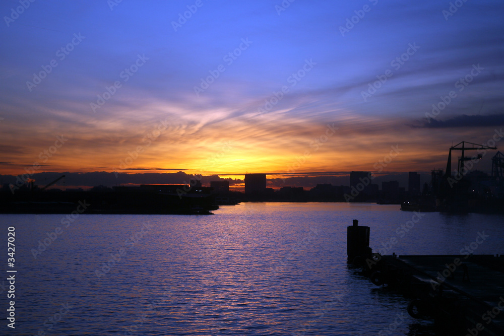 view of amsterdam harbour at sundown