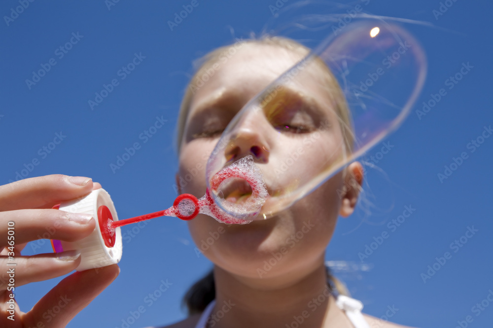 girl blowing soap bubbles girl blowing soap bubbles