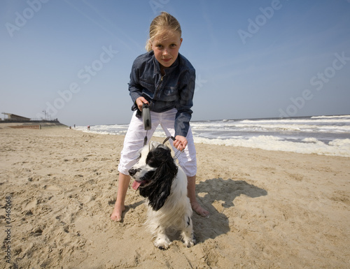 girl walking with her dog at the beach
