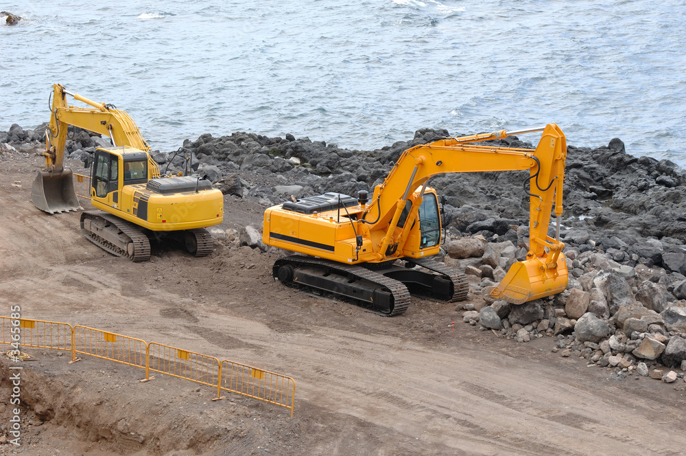 two orange excavators