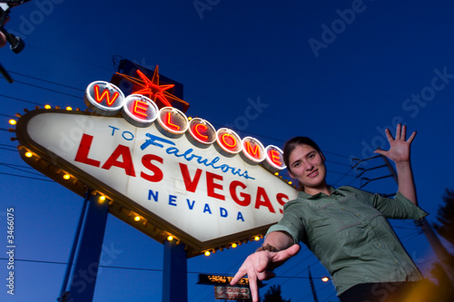 happy young woman at the welcome to las vegas sign