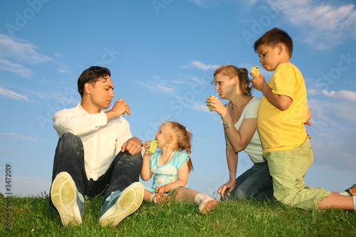 drinking family on a grass © Pavel Losevsky