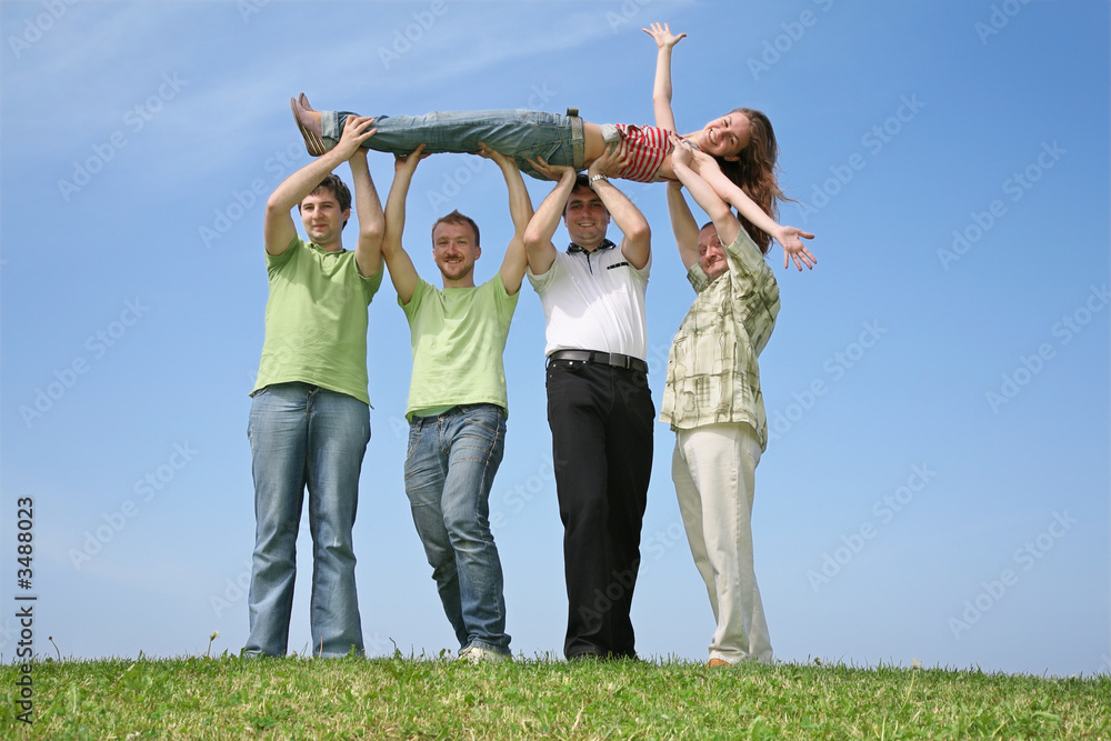 Four friends have lifted the girl upwards
