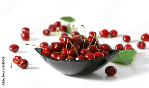 lots of red cherries in white dish