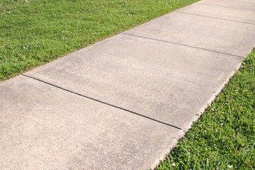 Abstract background of concrete sidewalk and grass