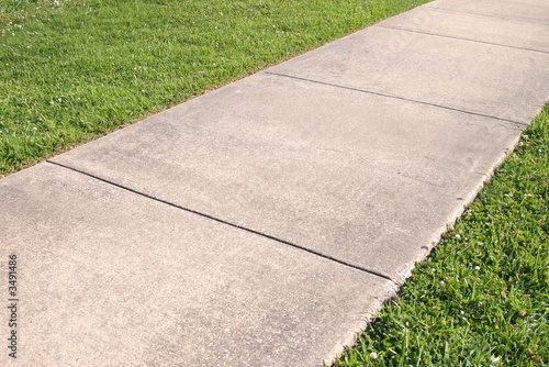 Abstract background of concrete sidewalk and grass