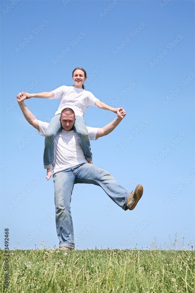 The girlfriend in a white T-short sits on the friend The girlfriend in a white T-short sits on the friend