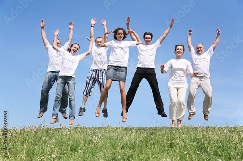 Seven friends in white T-shorts are in a jump