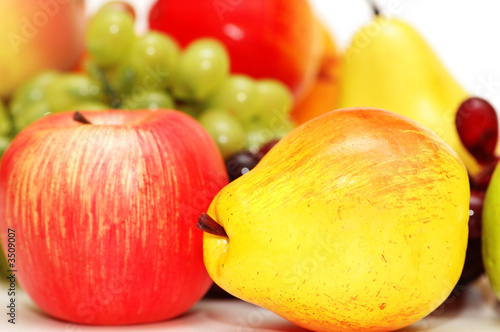 apple and pear and other fruits at background