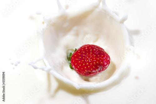 fresh strawberry splashing into the milk