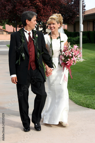 Bridal Couple Walking Hand in Hand photo