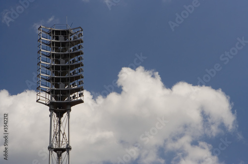 stadium searchlirht on blue sky with clouds photo