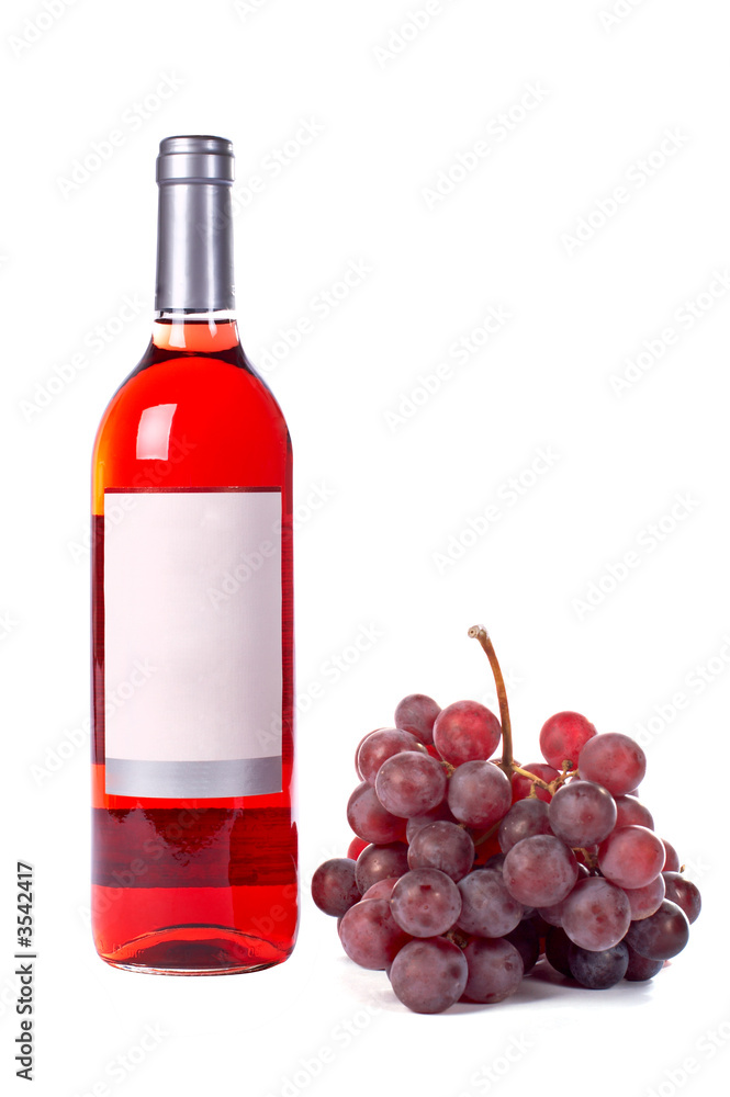 Grapes and wine bottle with label. White background with shadow