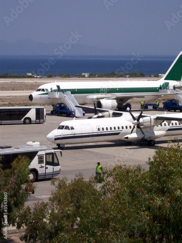 a number of airline aeroplanes at a busy airport