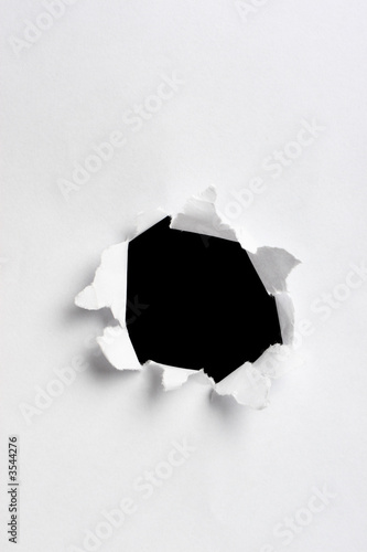 black hole in white paper with ragged edges