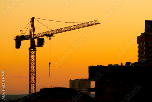 House building crane silhouettes against red evening skyset