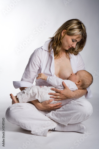 A mother nursing her infant.
